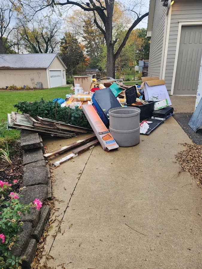 Dumpster being loaded with debris for Roofing Dumpster Rental in Siler City